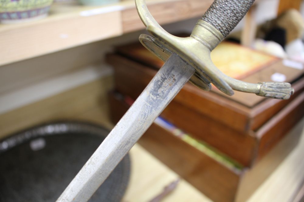A cut steel dress sword by Ede & Ravenscroft of London and two brass hilted dress swords